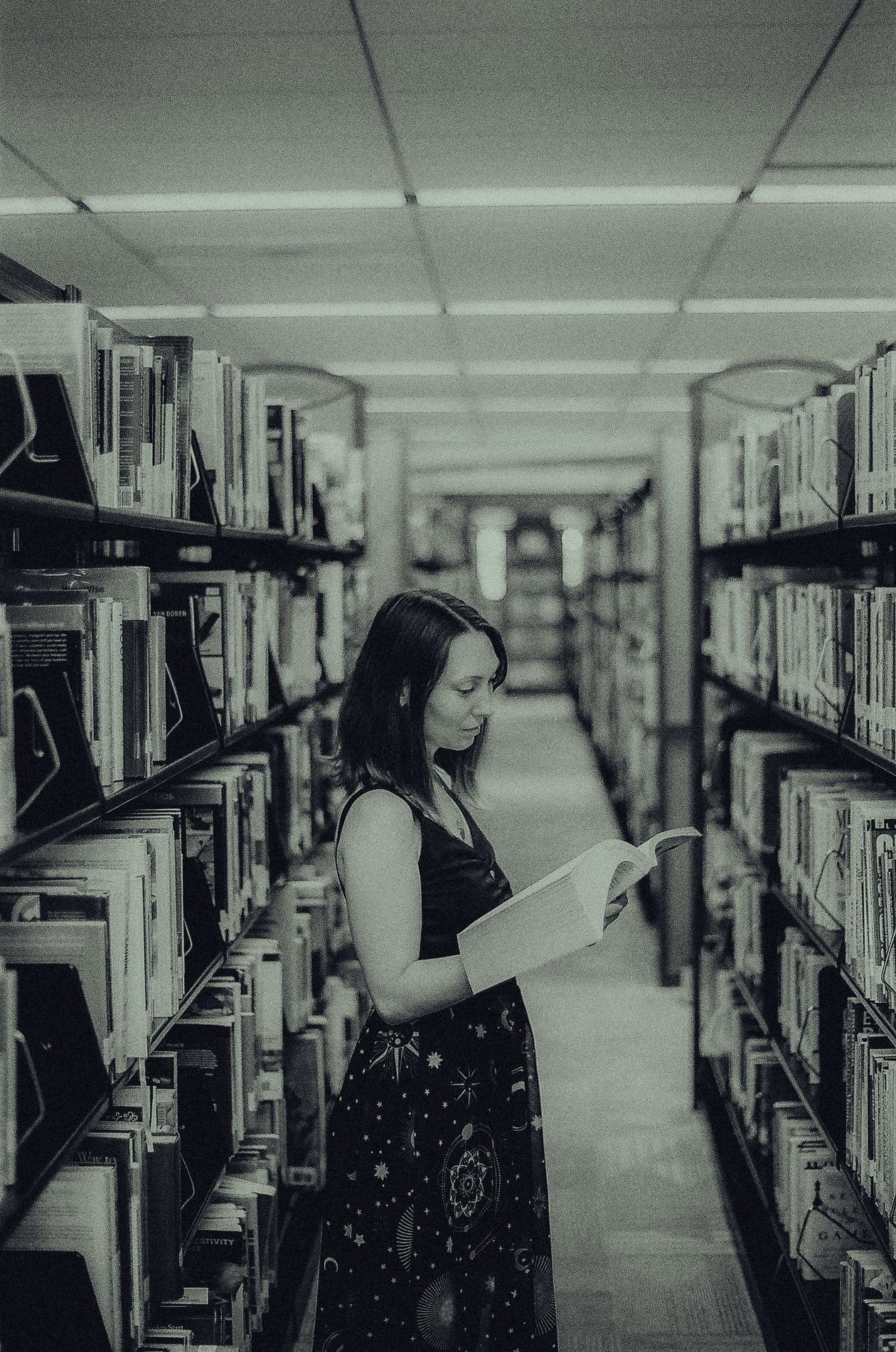Woman browsing a library, considering non-degree paths for a career change
