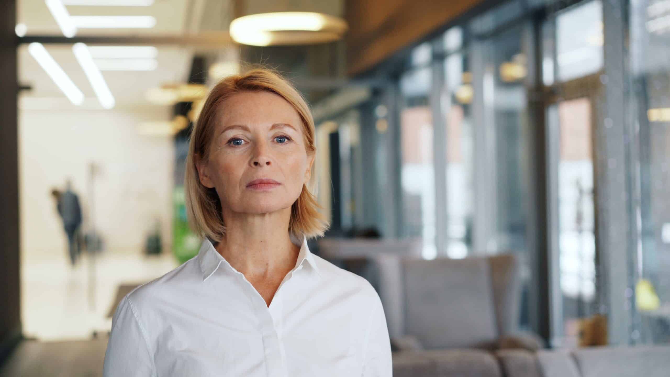Confident businesswoman in a bright office, ready to return to work