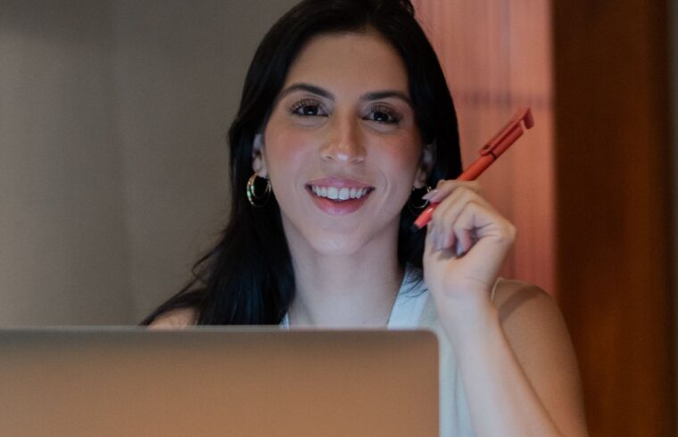 Confident woman over 40 working on a laptop, building a side hustle