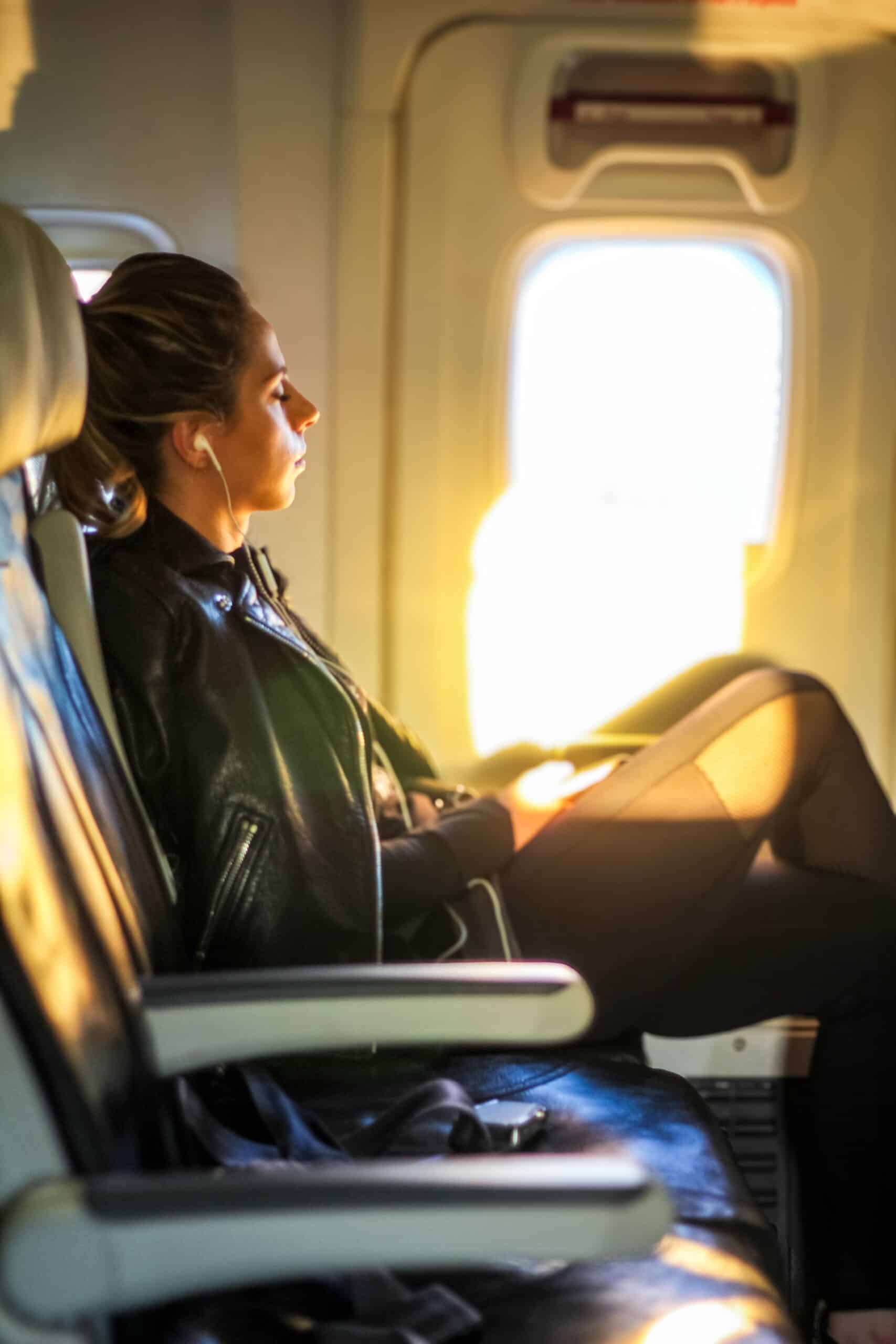 Woman gazing out a window peacefully, reflecting on a career break