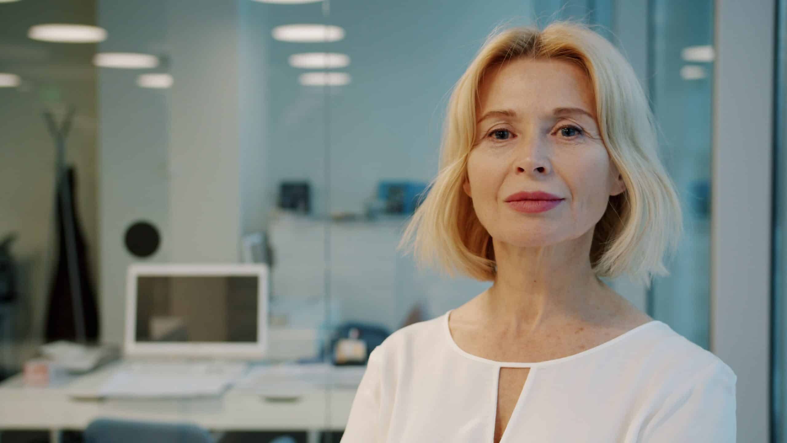 confident woman in her 40s in a bright office setting