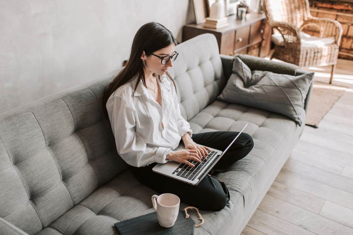 Woman learning virtual assistant tools on her laptop at home