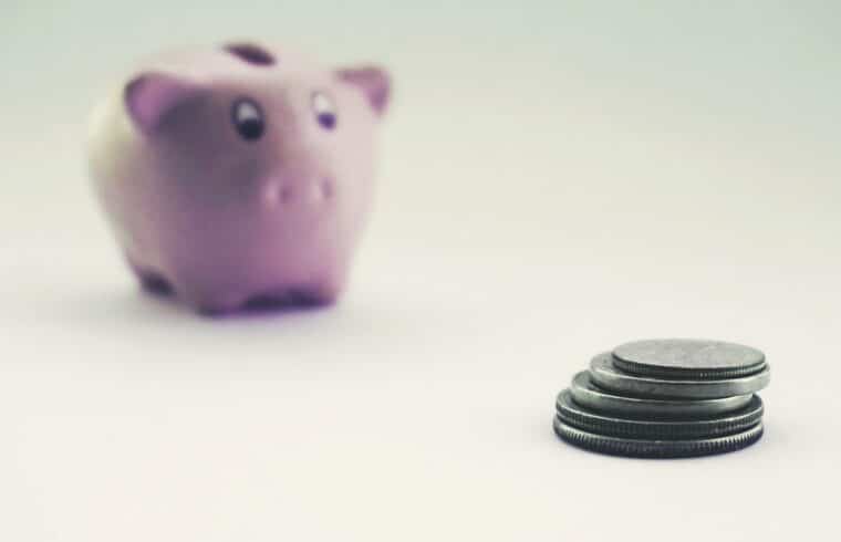 Coins and a piggy bank representing an emergency fund before a career change