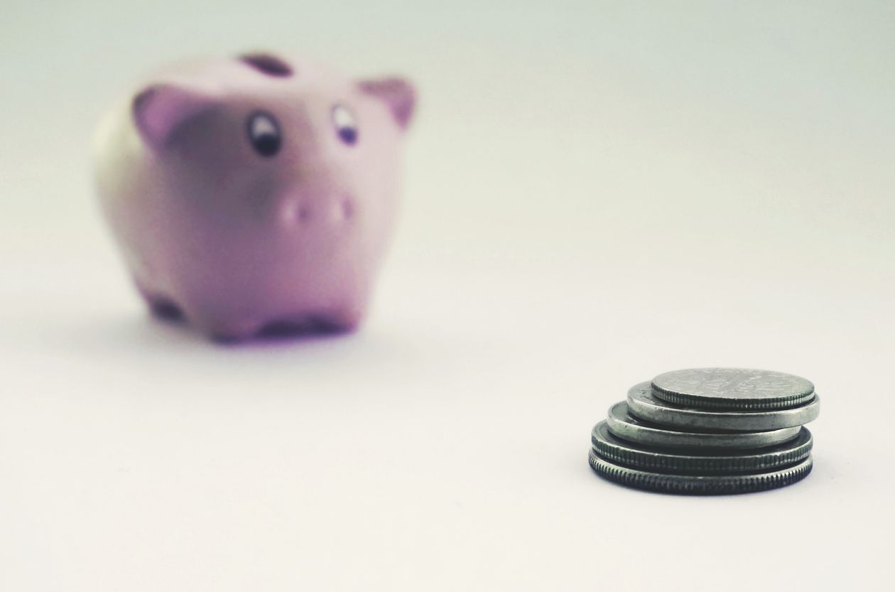 Coins and a piggy bank representing an emergency fund before a career change