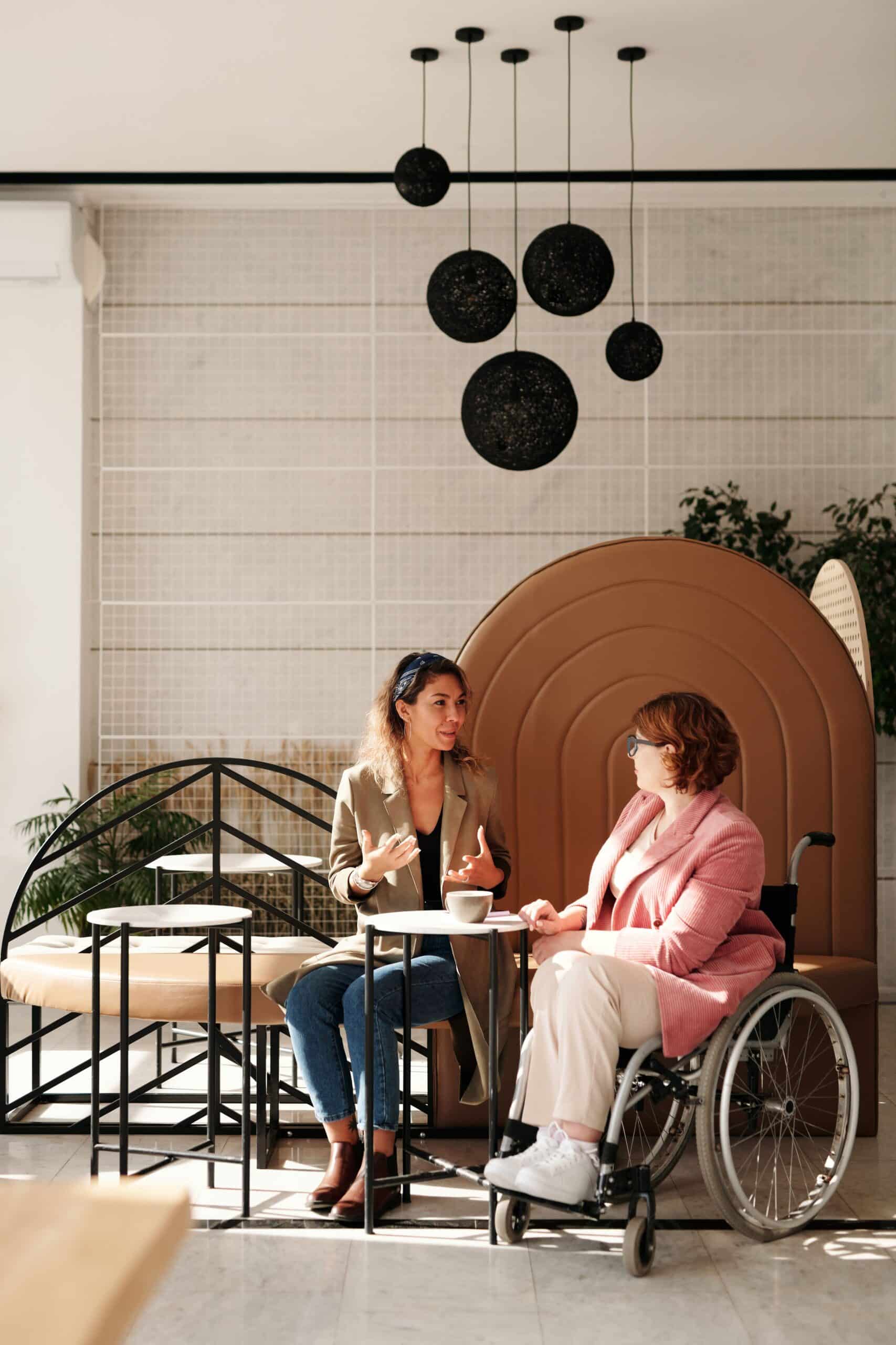 Two women talking warmly together, building a professional relationship