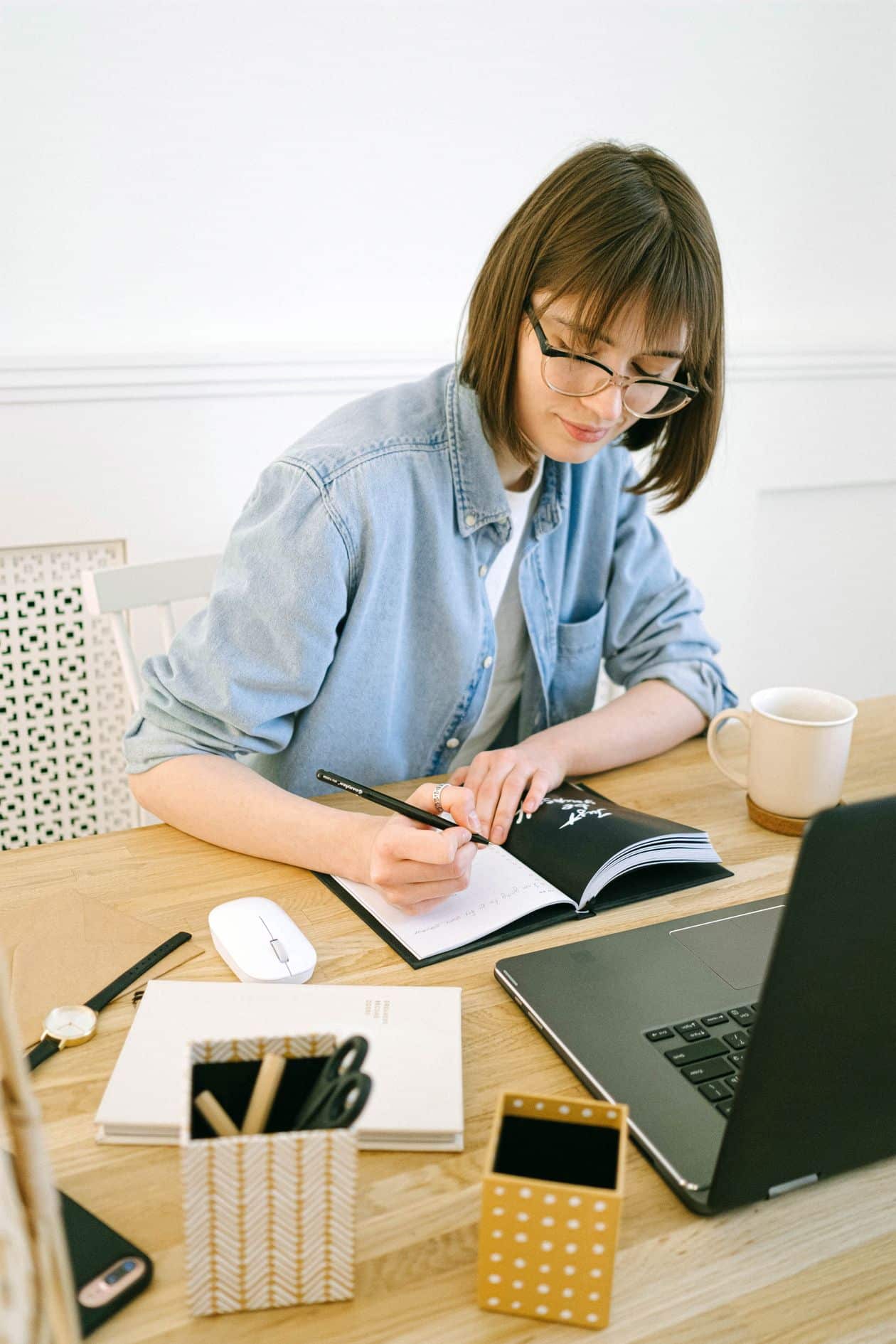 Woman writing in a notebook, drafting freelance writing samples