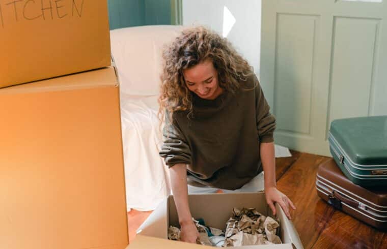Woman unpacking boxes in her new home after divorce, starting fresh