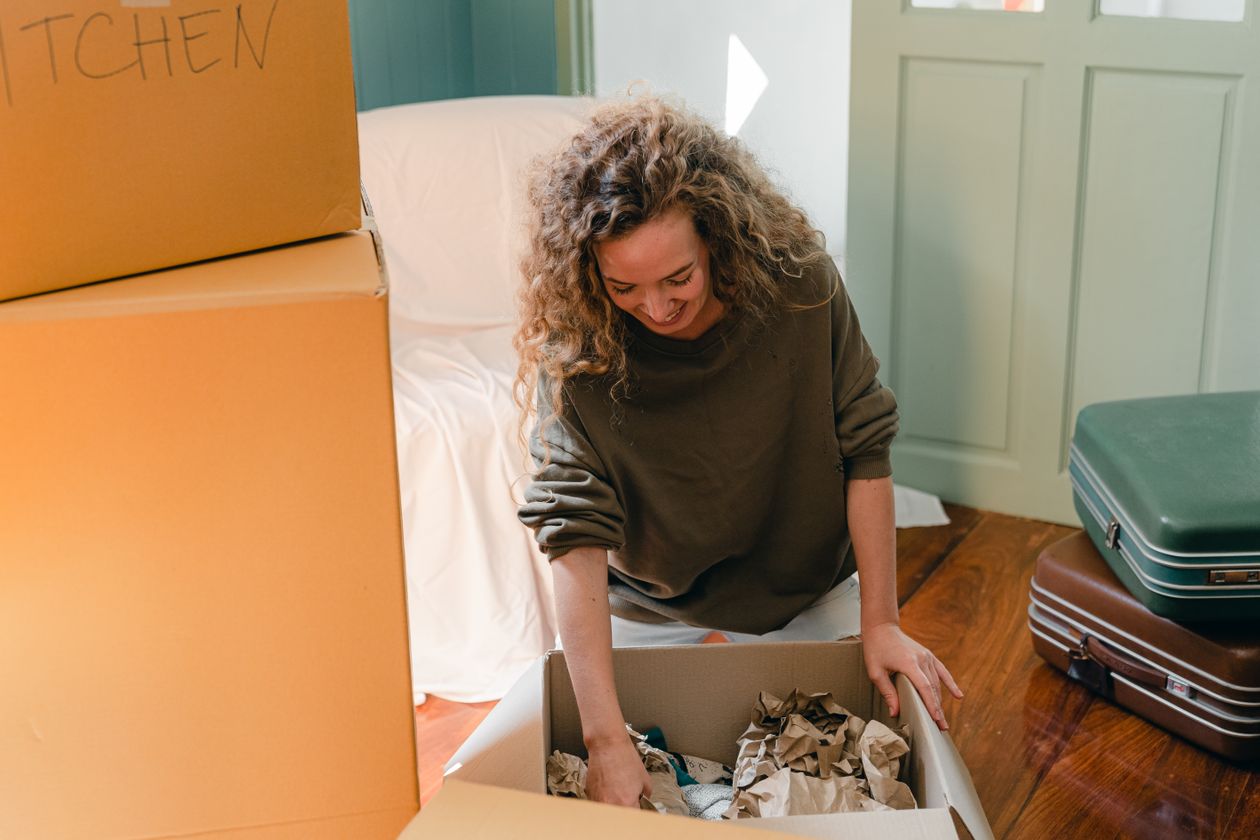 Woman unpacking boxes in her new home after divorce, starting fresh