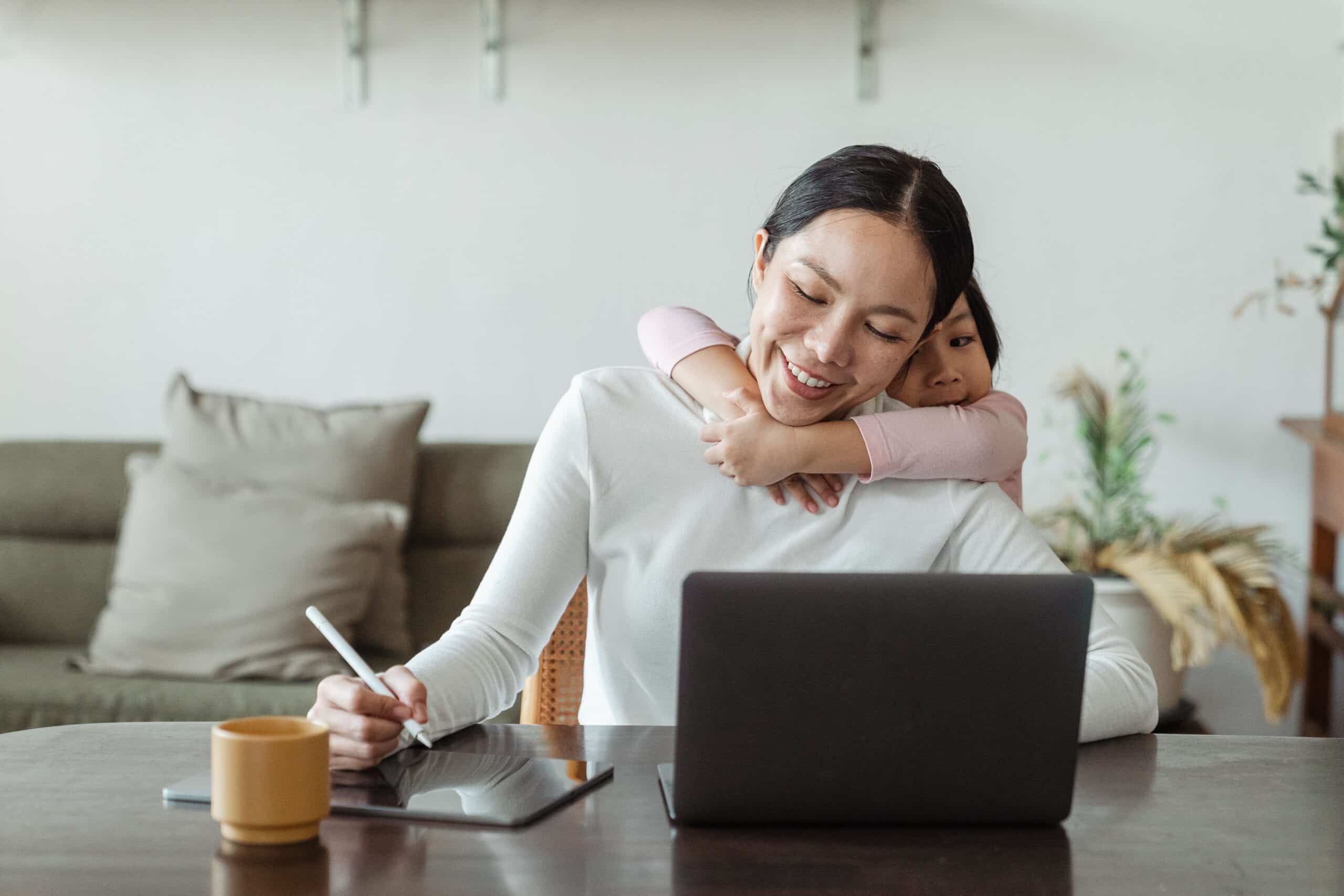 Woman confidently using a laptop at home before returning to work