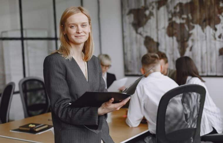 Businesswoman in a suit in a meeting, weighing whether an MBA is worth it after 40