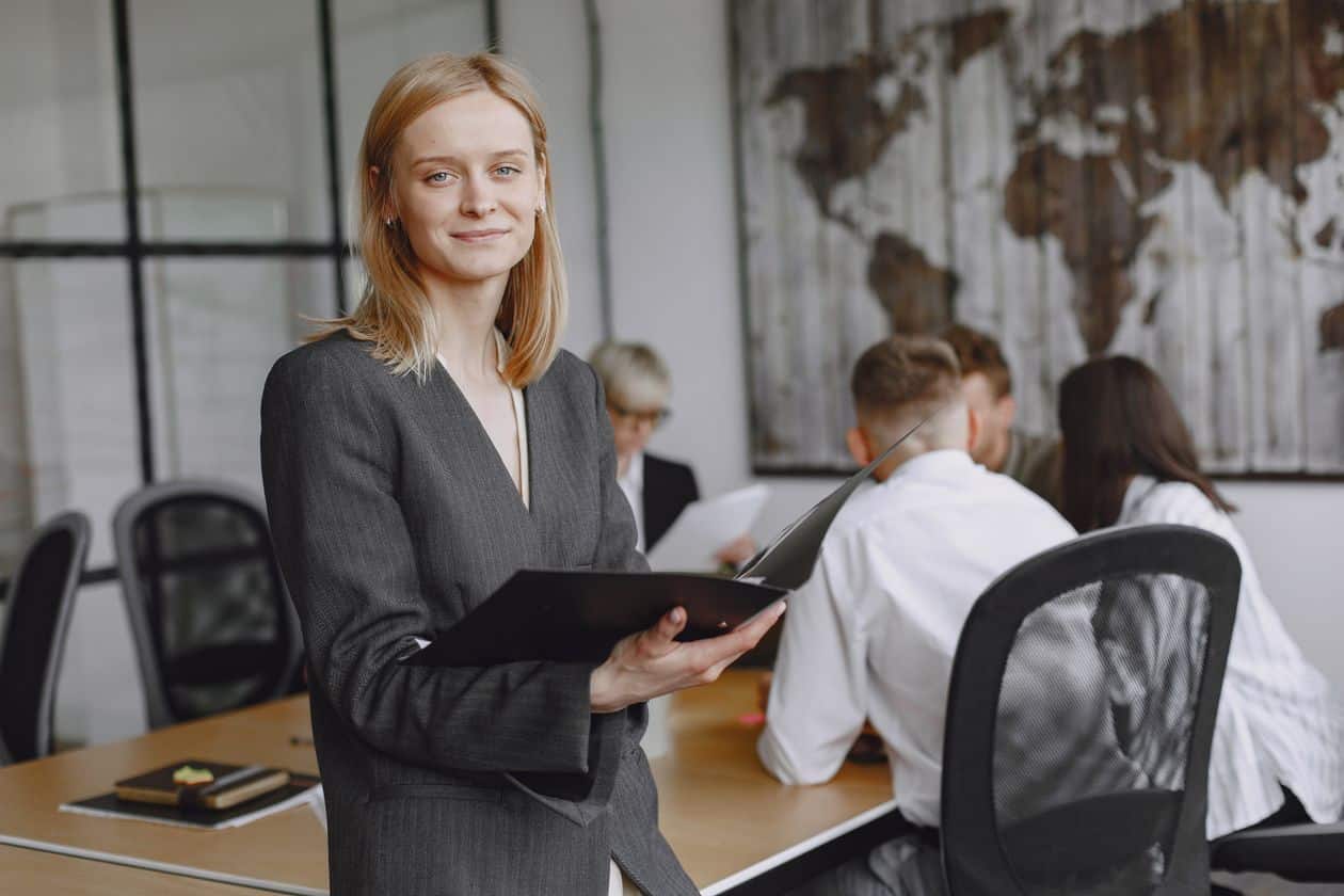 Businesswoman in a suit in a meeting, weighing whether an MBA is worth it after 40