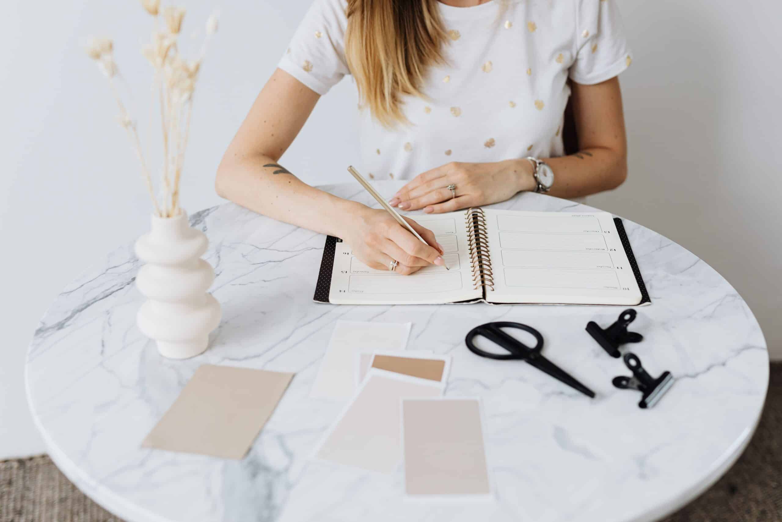 Woman writing in a planner while taking stock of her career direction