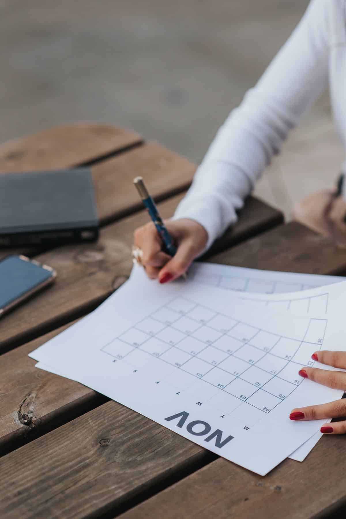 Woman scheduling her business timeline in a calendar