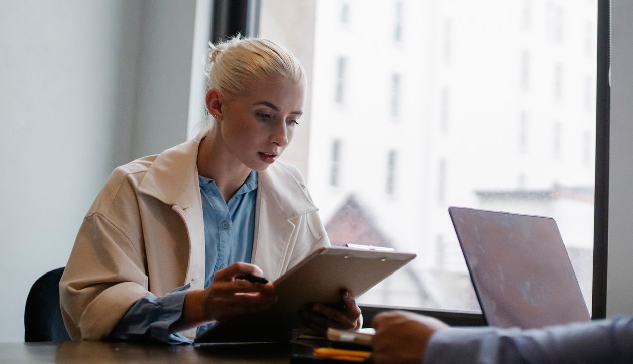 Businesswoman reading documents in an office, weighing when an MBA is a weaker financial bet