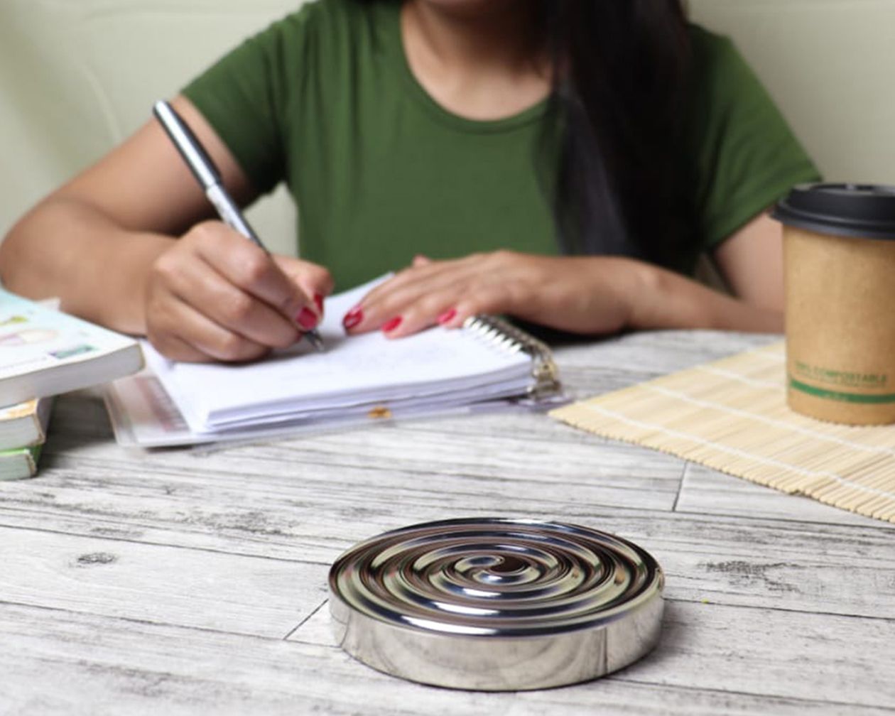 Woman writing in a notebook while planning her budget