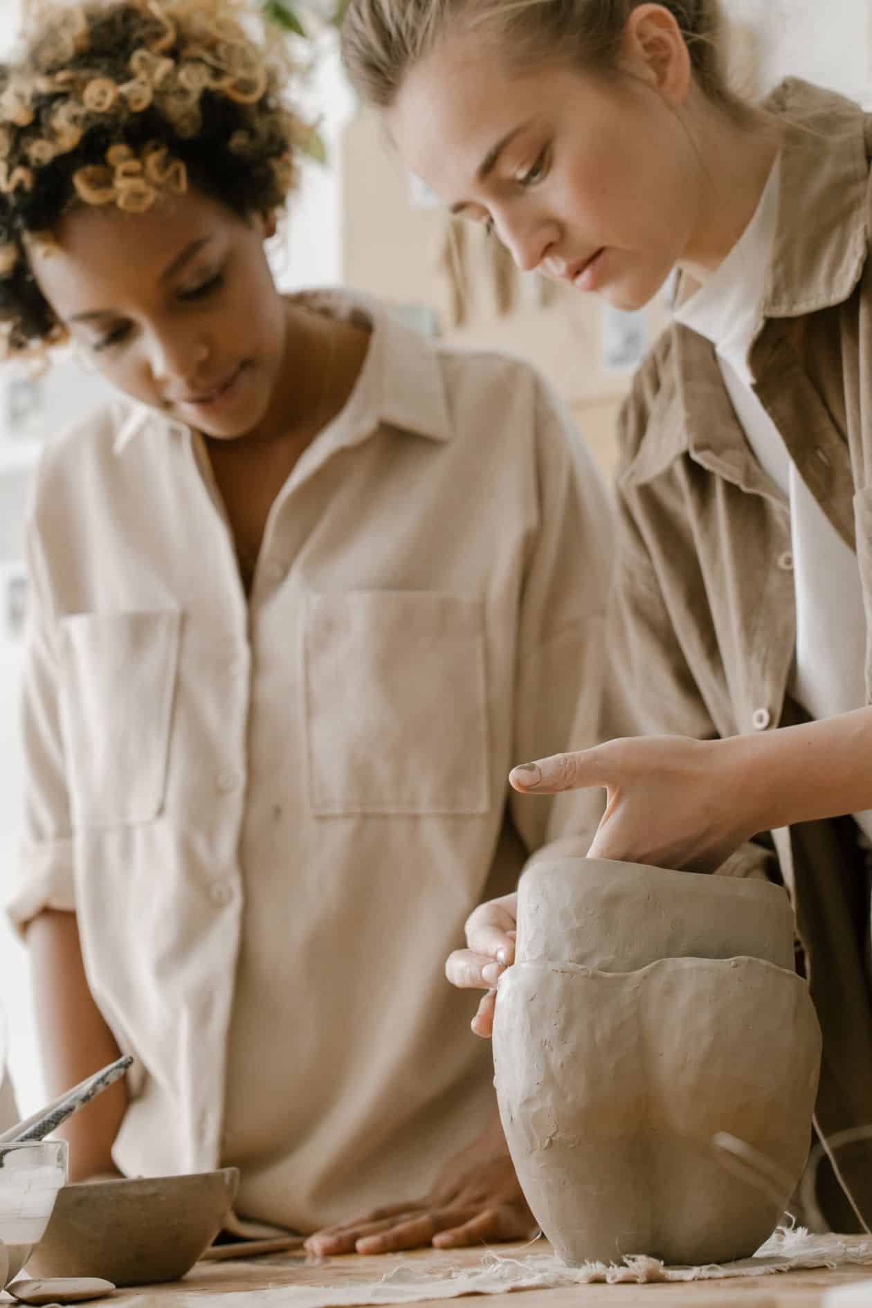 Women engaged in pottery, deciding whether to grow their craft business