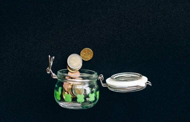Coins saved in a jar, representing a savings cushion before quitting a job