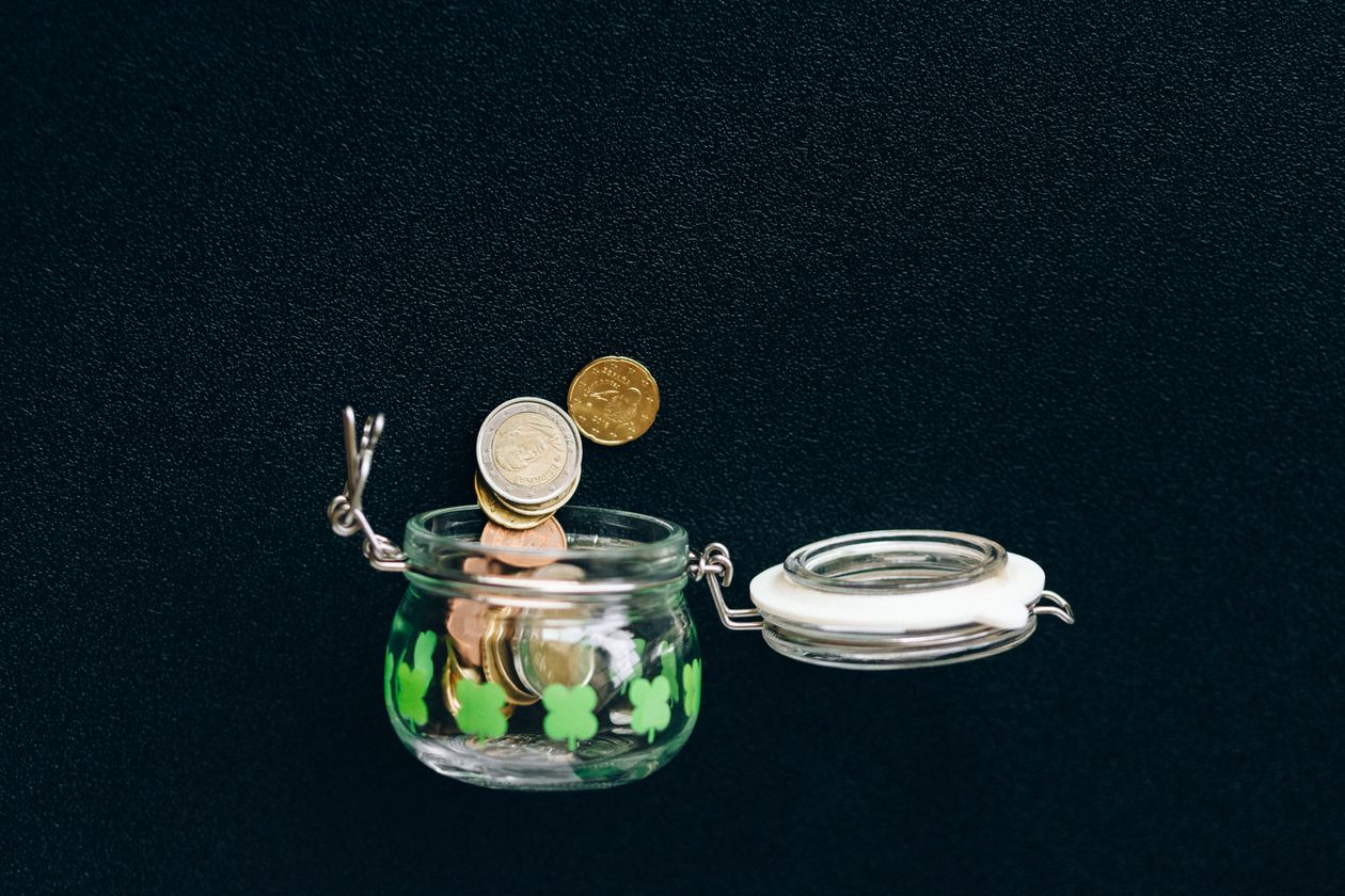 Coins saved in a jar, representing a savings cushion before quitting a job