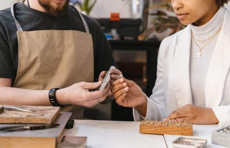 Woman holding a handmade silver ring, representing an Etsy shop selling handmade jewelry