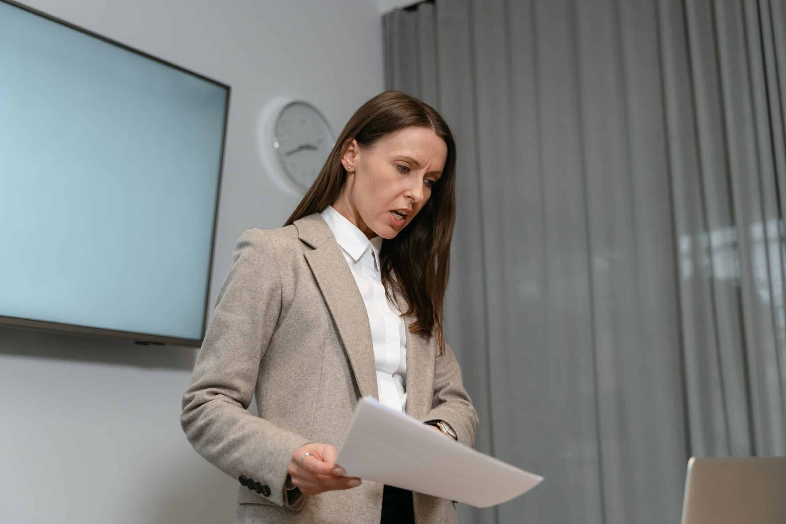 businesswoman reviewing documents at her desk