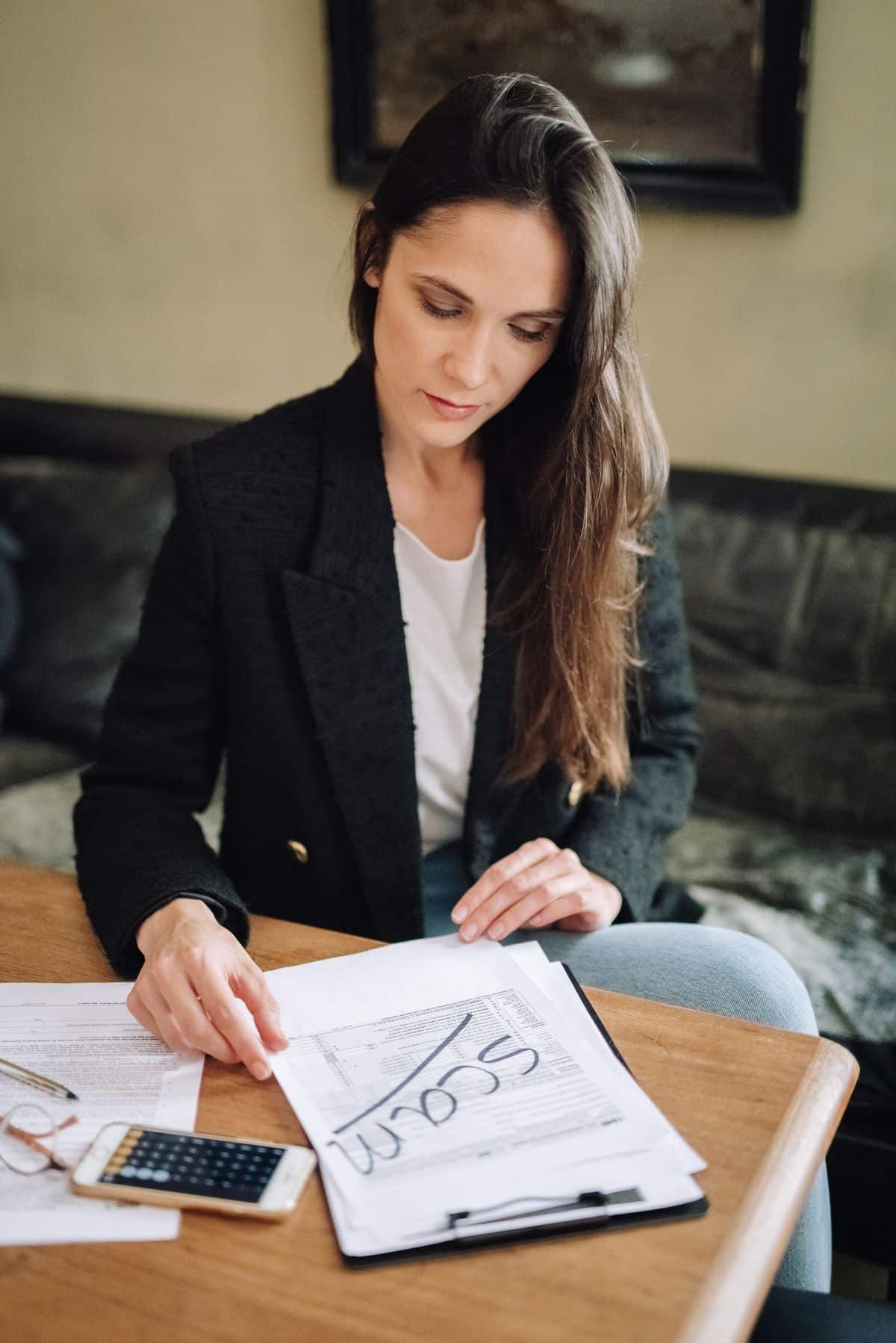 Woman comparing certification options with documents at her desk