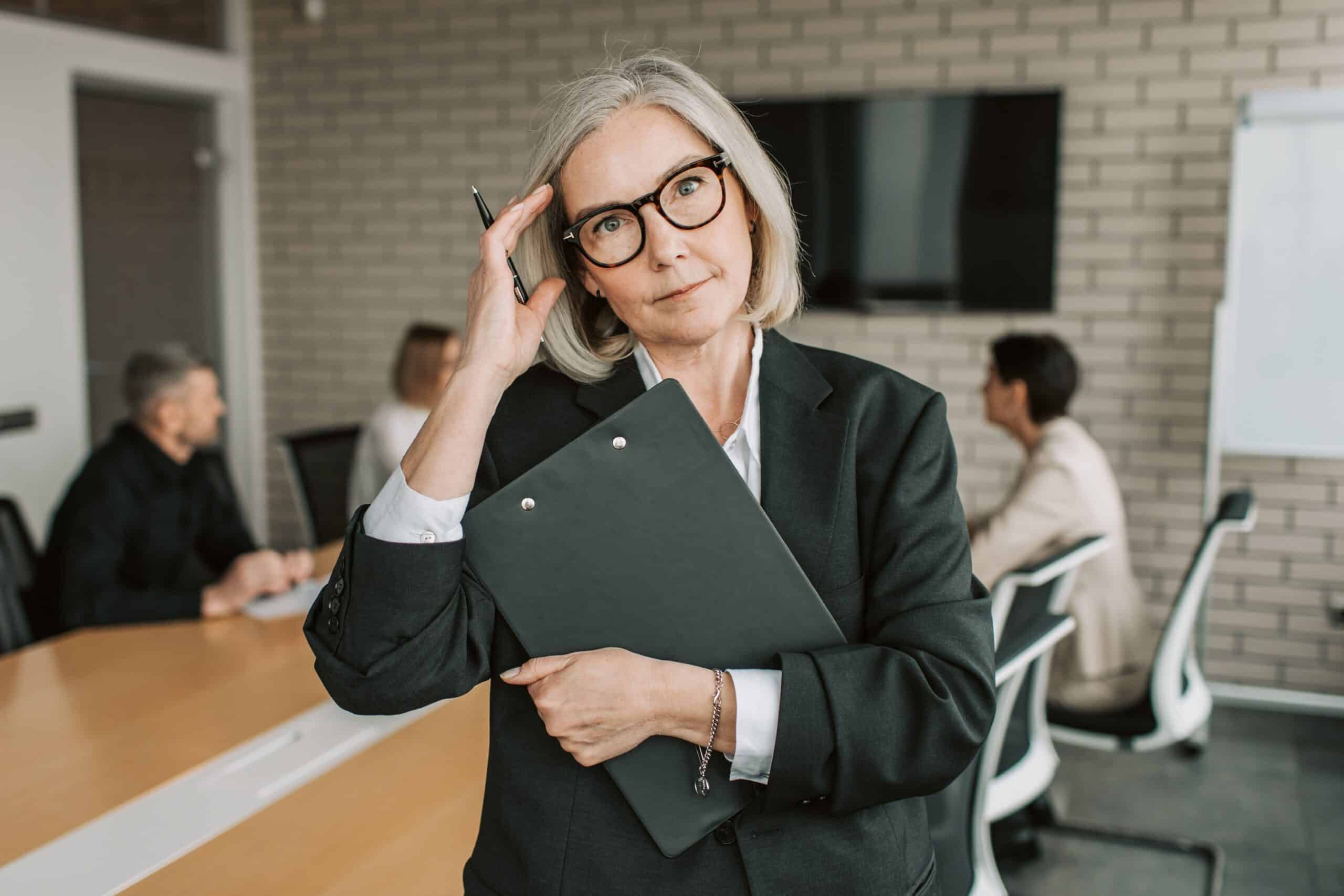 senior businesswoman with clipboard in a professional office
