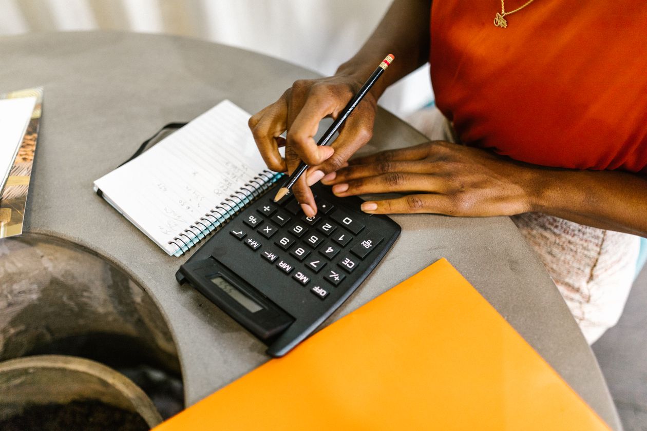 Woman using a calculator to estimate startup costs