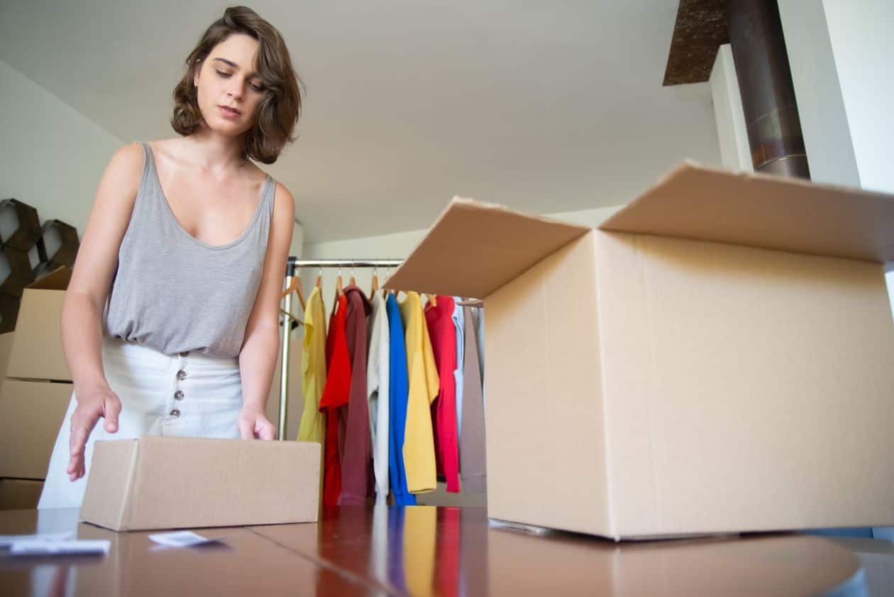 Woman packing handmade merchandise to ship from her Etsy shop