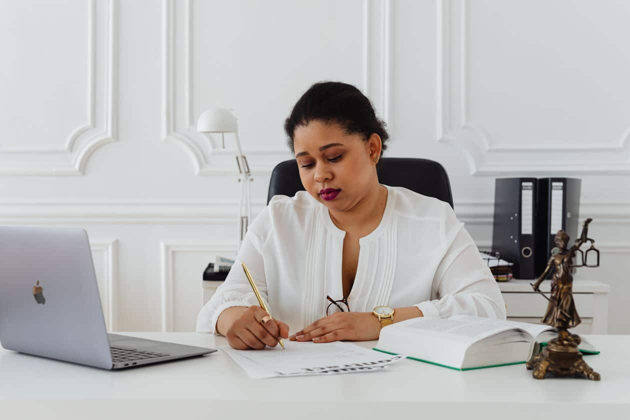 Woman at her office desk signing a severance agreement