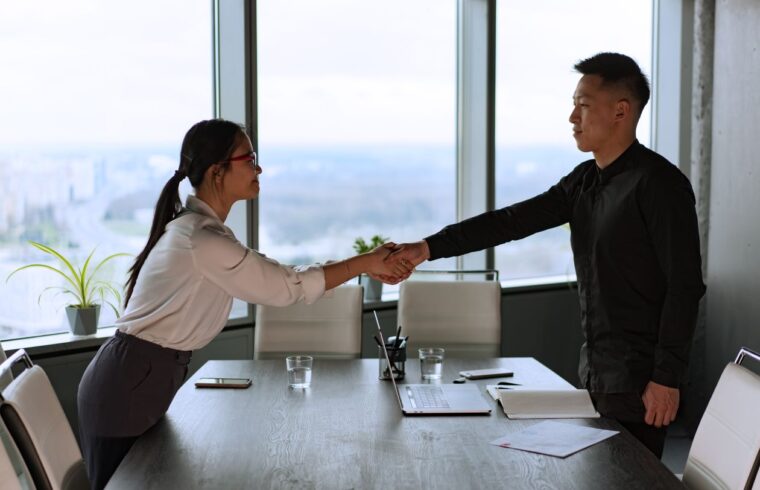 Man and woman shaking hands after a successful negotiation