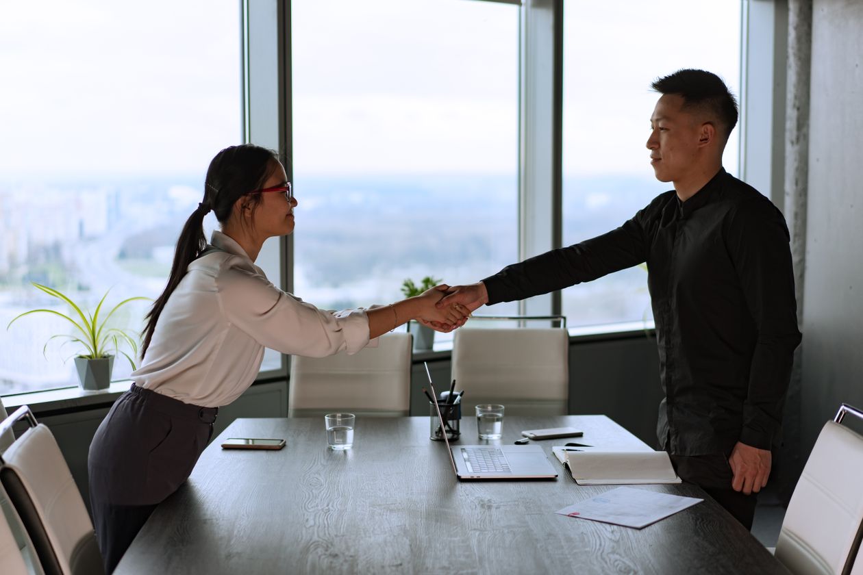 Man and woman shaking hands after a successful negotiation