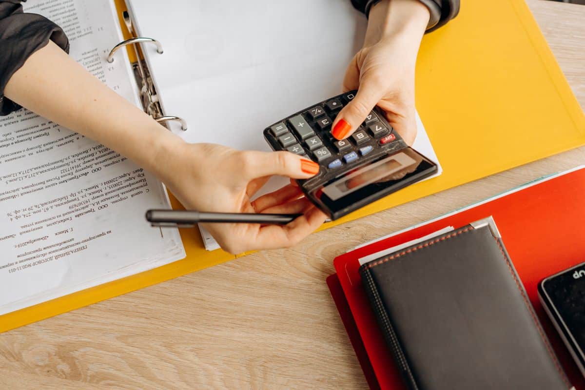Woman using a calculator, representing bookkeeping work