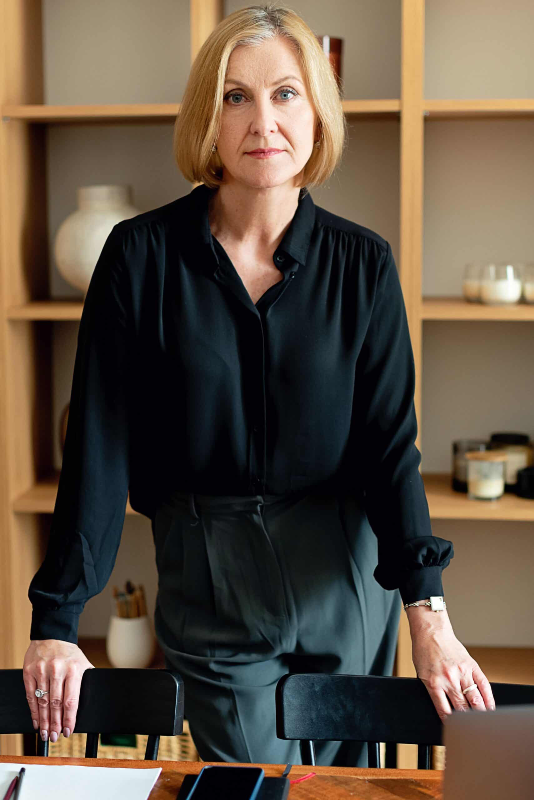 Confident woman in her 40s standing in a modern office, symbolizing a fresh career start