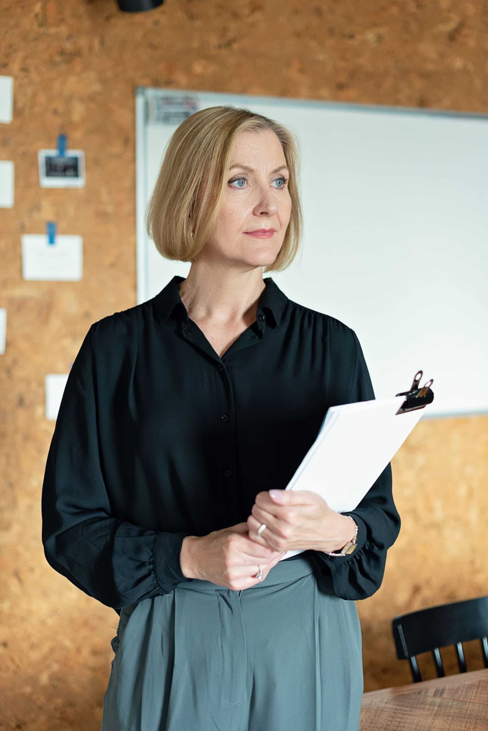 professional businesswoman with clipboard leading a meeting