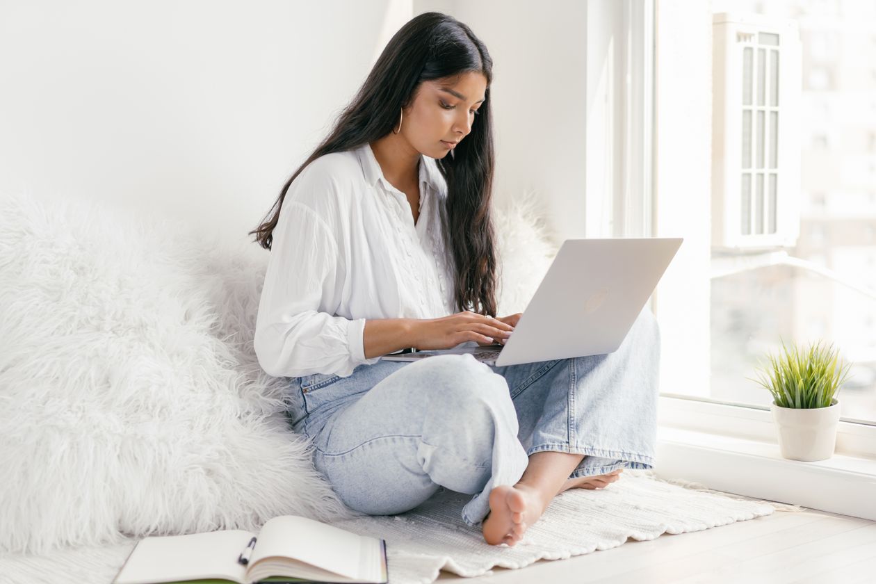 Woman reviewing certificate program options on a laptop