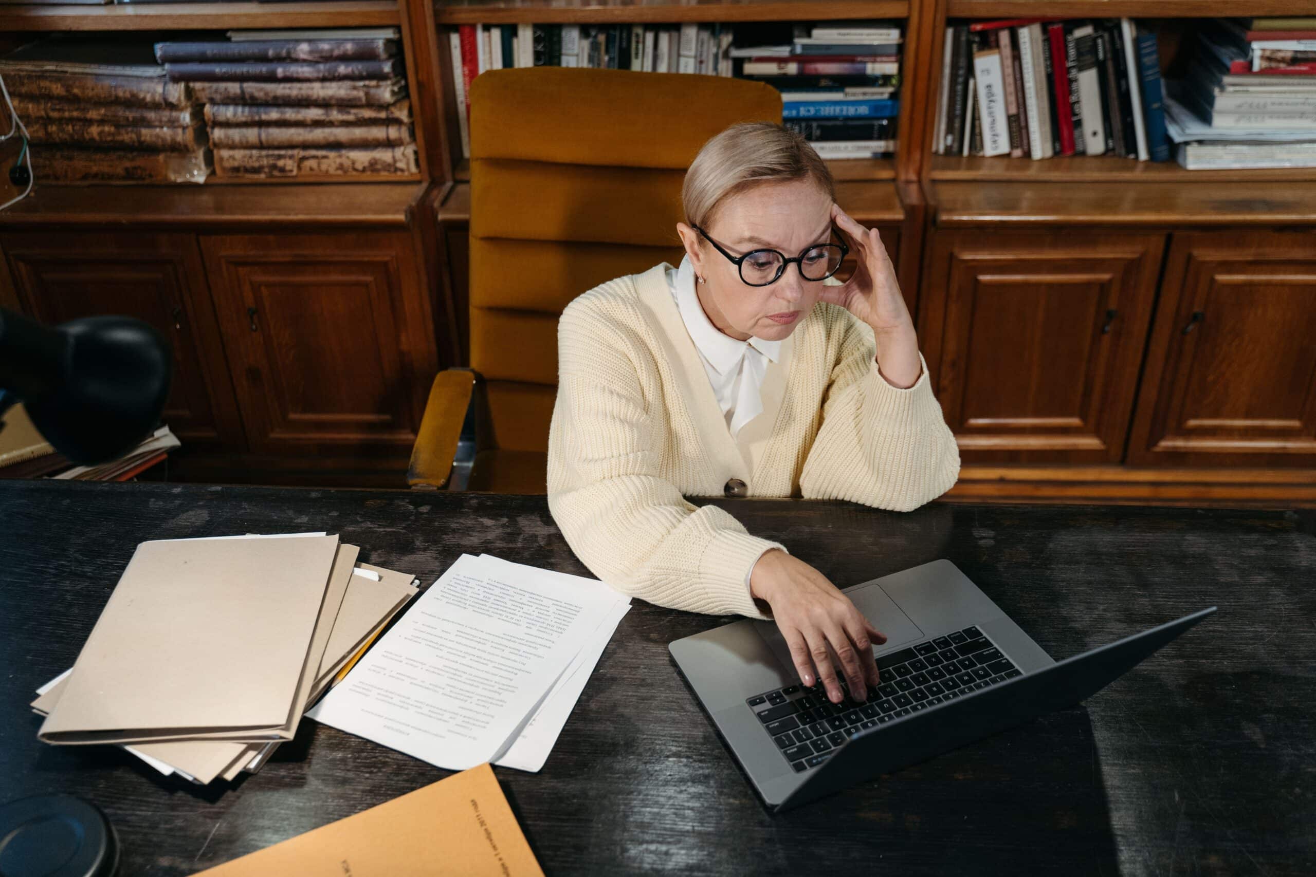 Woman researching current job requirements on a laptop