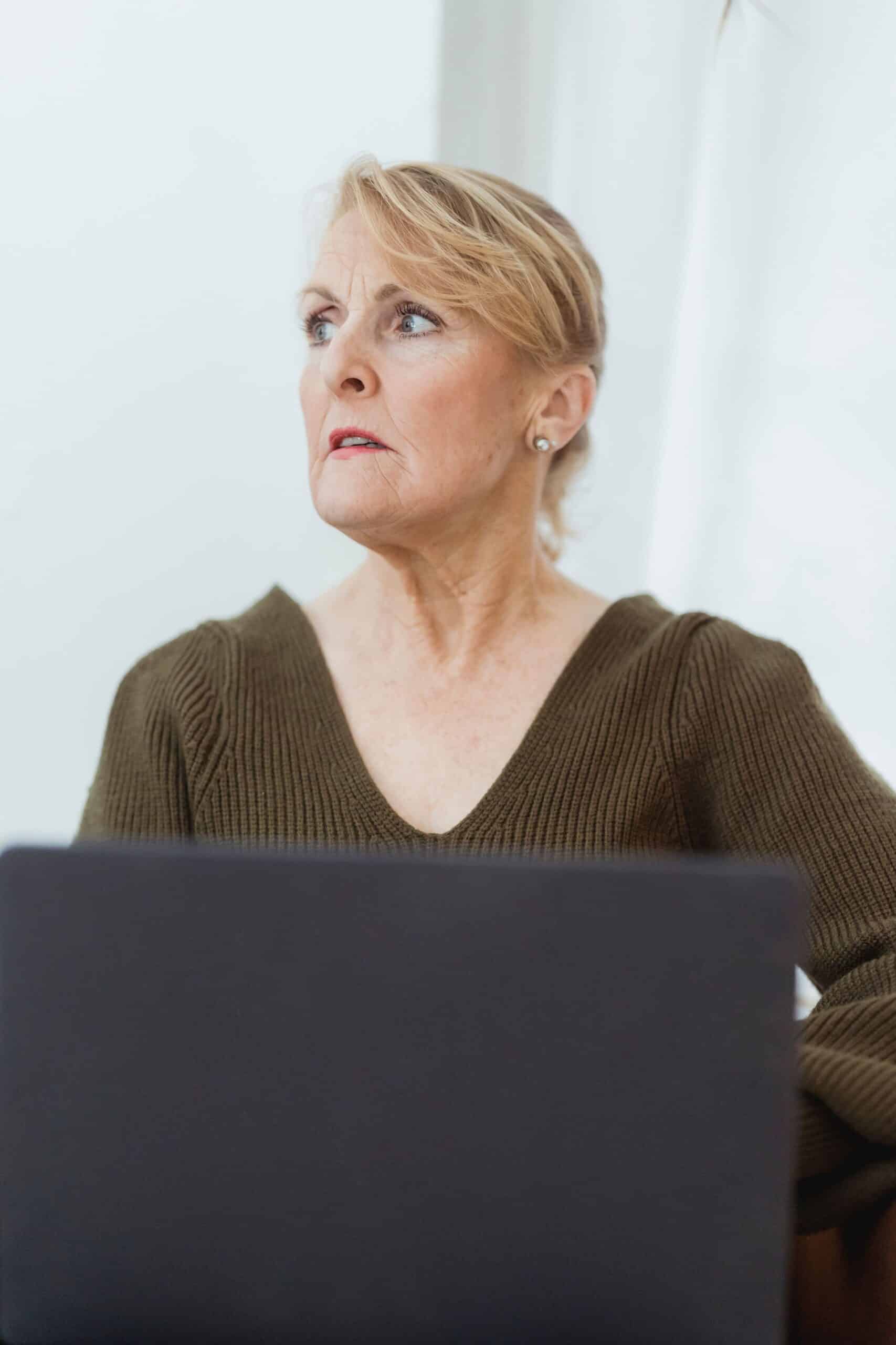 Mature woman working on a laptop from home during the holiday season